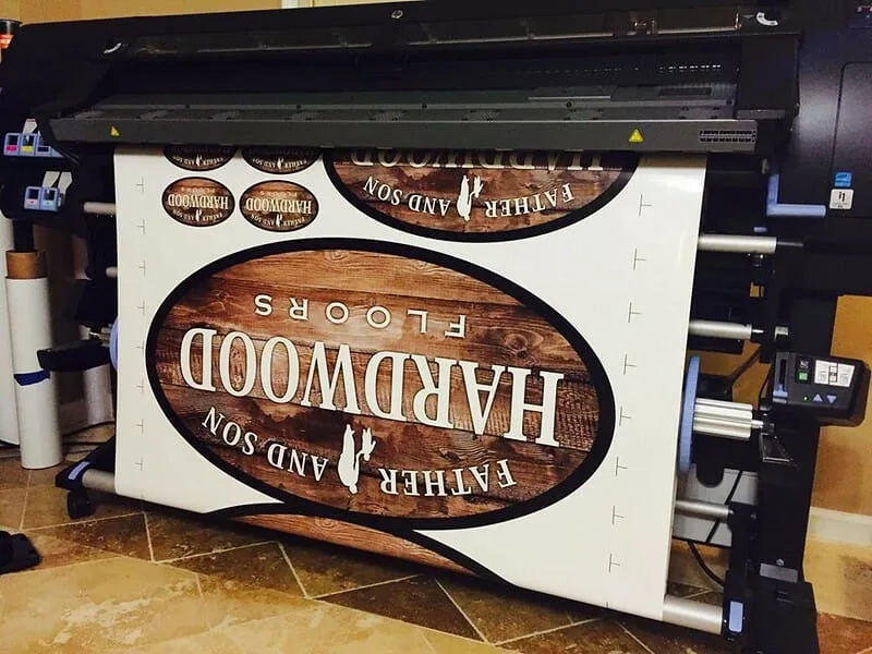 PV Wraps shop with large format printer producing vinyl graphics