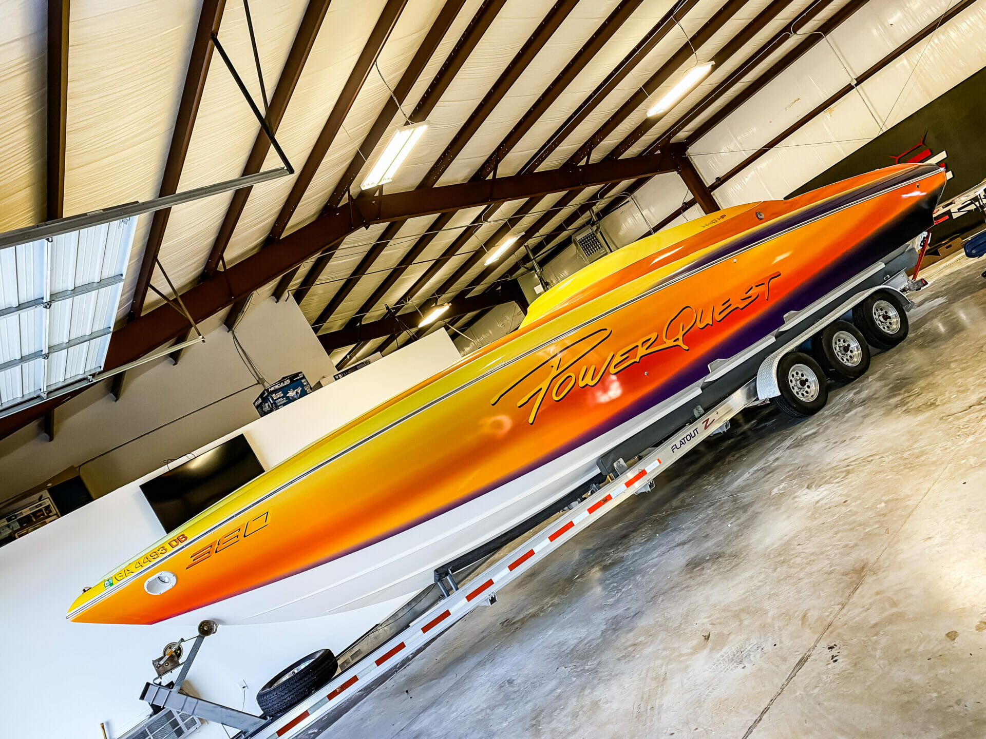 PowerQuest boat in shop during wrap installation